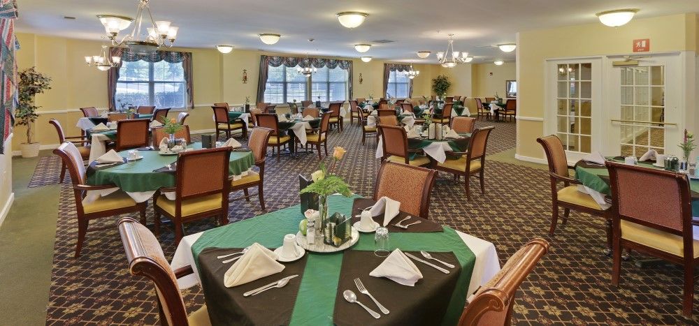 An elegantly set dining area with neatly arranged tables and chairs.