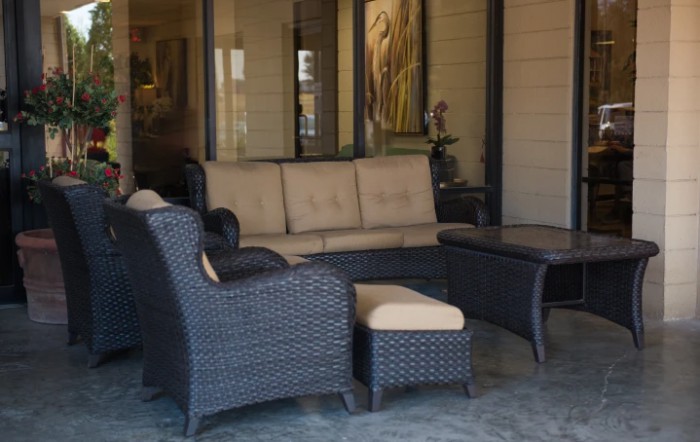 A cozy outdoor patio set with wicker furniture and comfortable cushions.