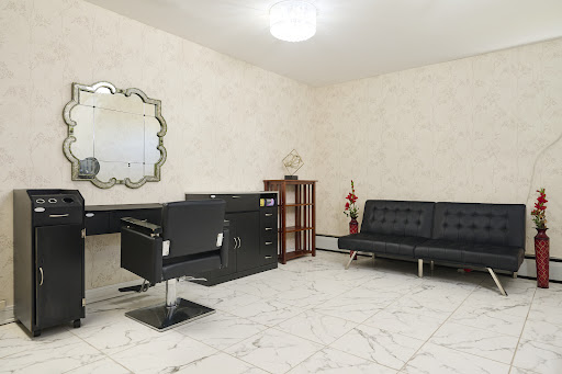 A spacious and modern office interior featuring a sleek desk, comfortable seating, and elegant decor.
