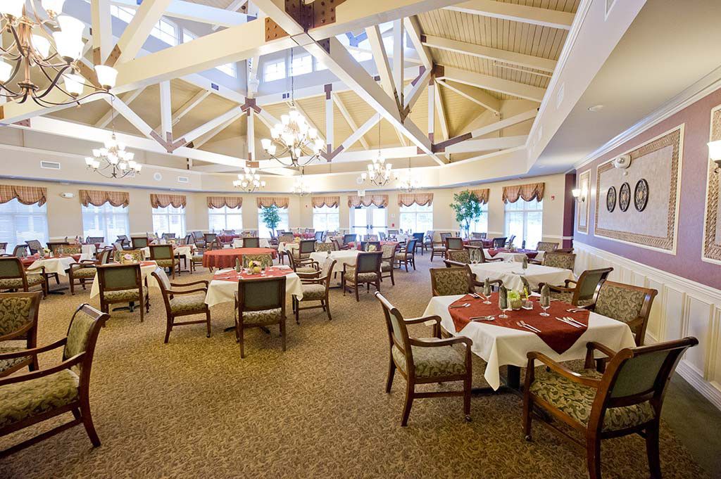 Elegant dining room with chandeliers and neatly arranged tables.
