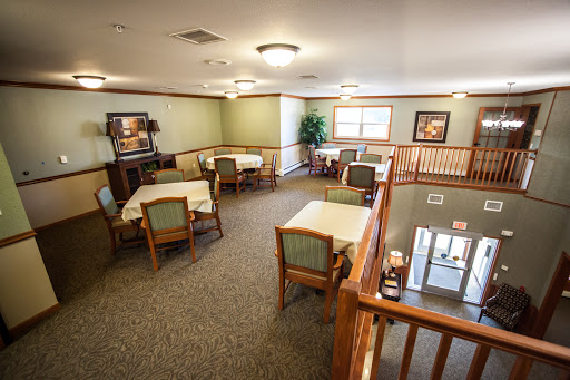 A spacious dining area designed for communal meals, featuring tables and chairs arranged for comfort.