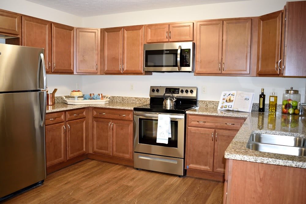 A modern kitchen with wooden cabinets and stainless steel appliances.