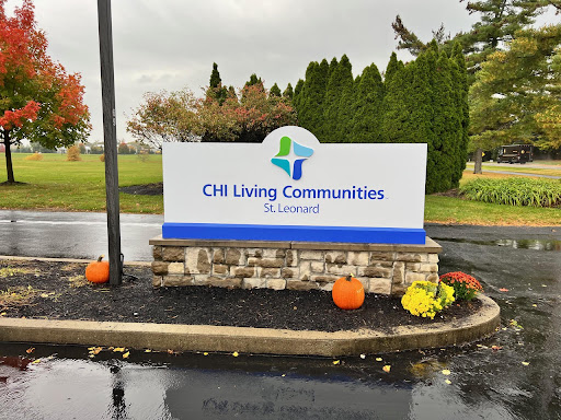 Entrance sign for CII Living Communities, decorated with autumn elements.