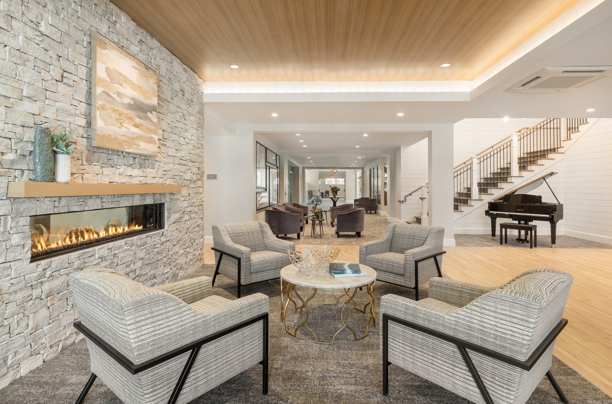 A modern living room with comfortable seating and a cozy fireplace.
