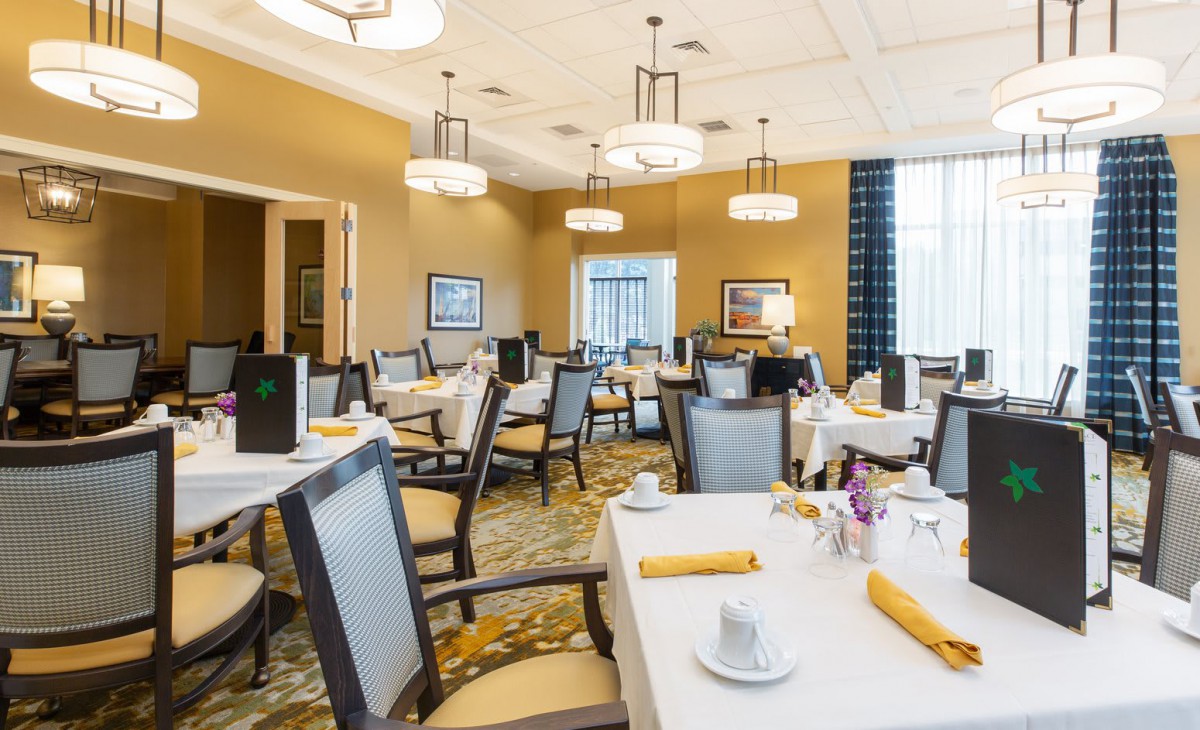 Elegant dining room with neatly set tables and modern decor.