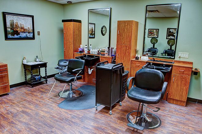 A neat and well-organized hair salon interior with styling chairs and mirrors.