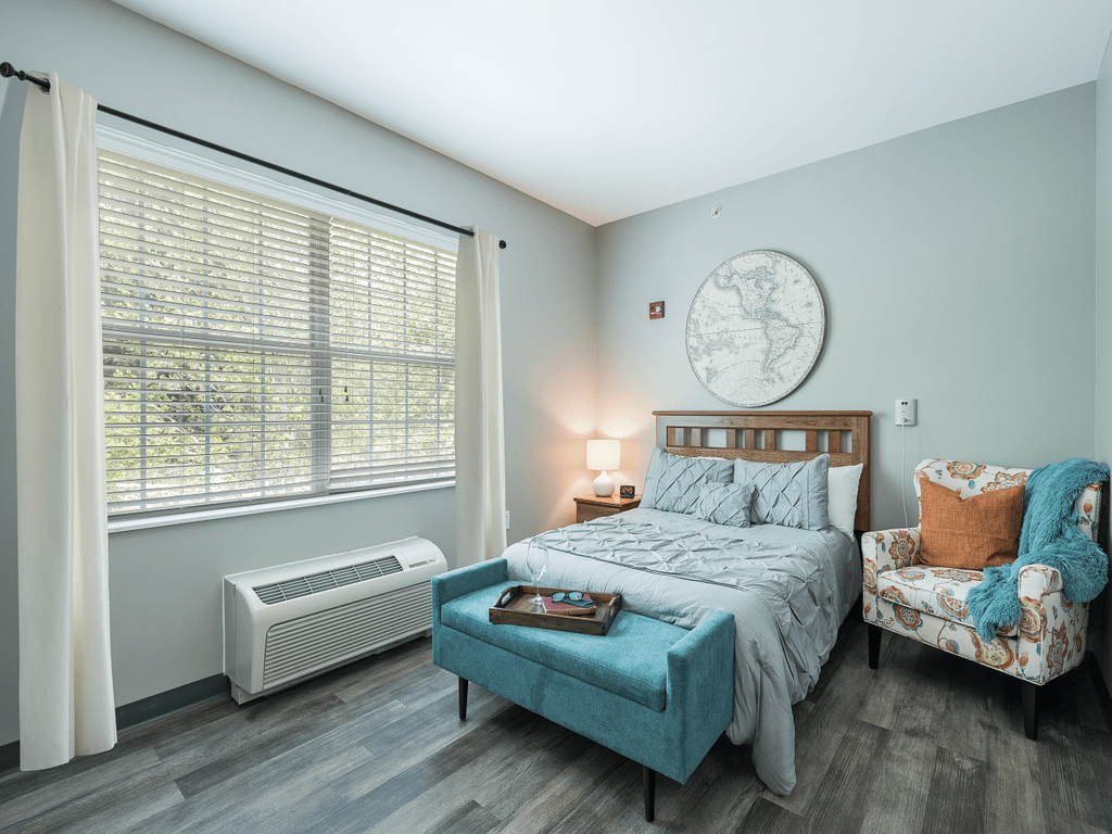 A modern bedroom with stylish decor and natural lighting.