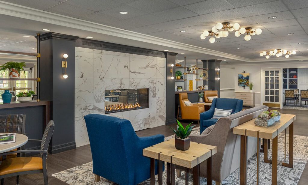 A modern lounge area featuring comfortable seating and a stylish fireplace.