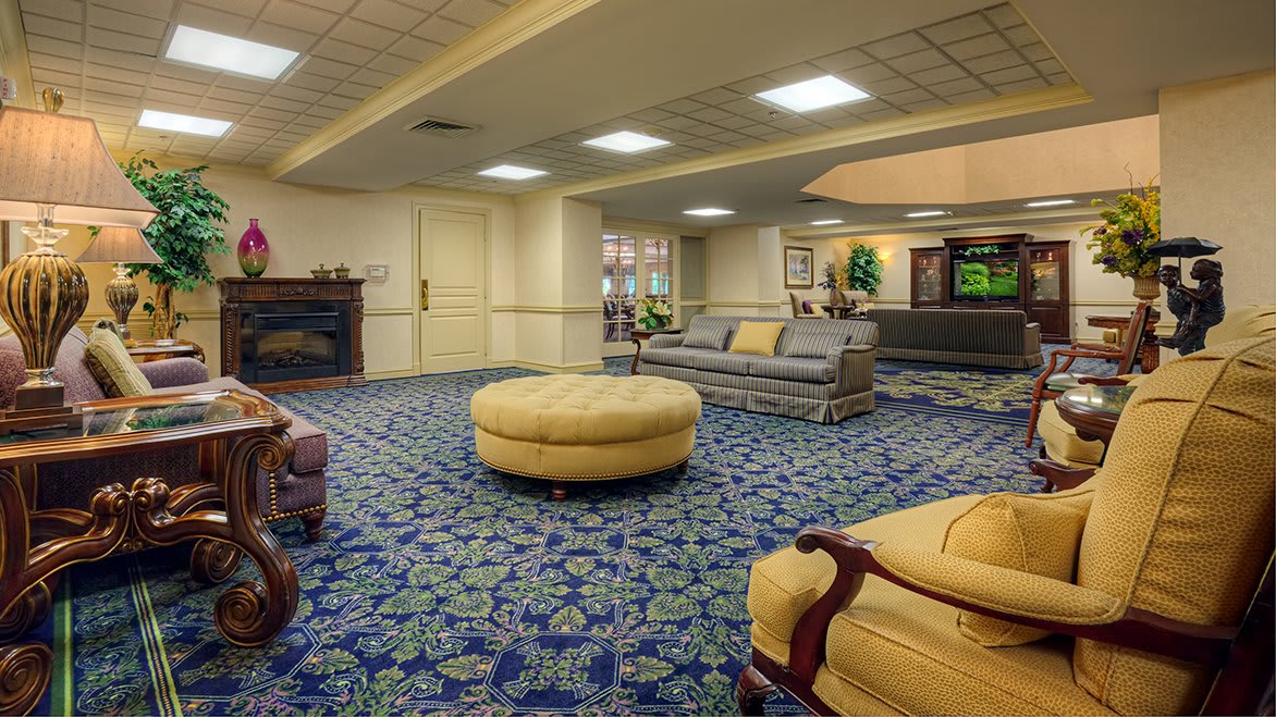 A spacious lobby with comfortable seating and patterned carpet.