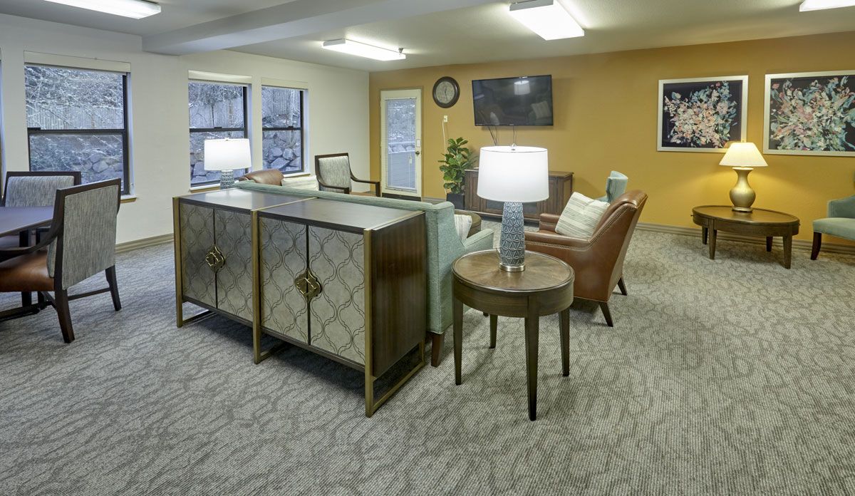 A cozy lobby or reception area featuring comfortable seating, a television, decorative lamps, and a welcoming atmosphere.