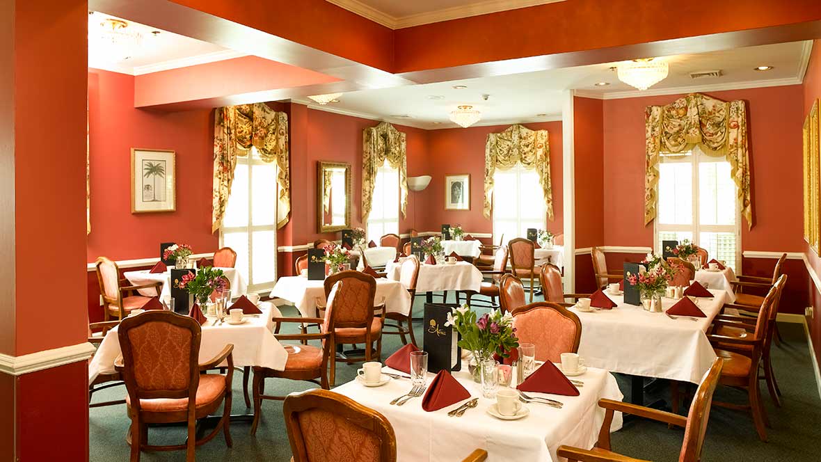 An elegant restaurant dining area with beautifully set tables and classic decor.