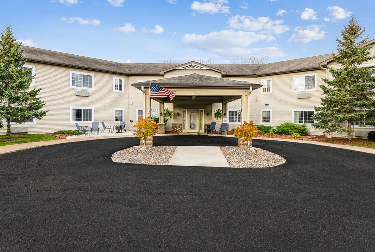 A commercial building with a landscaped entrance and a welcoming driveway.