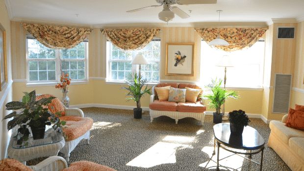 A well-lit living room with elegant furniture and decor.