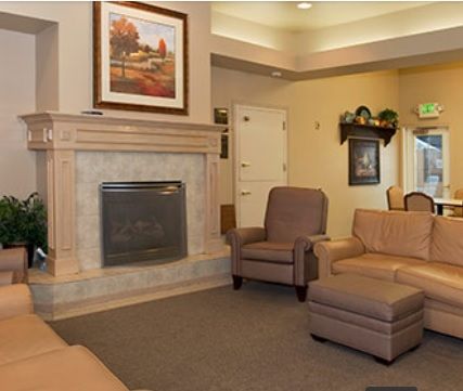 A cozy living room with a fireplace and comfortable seating.
