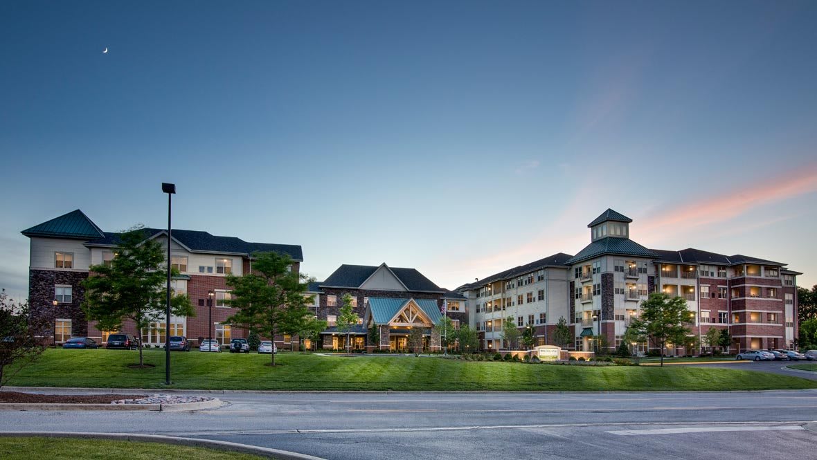 A large resort hotel complex with a beautifully landscaped exterior under a clear evening sky.