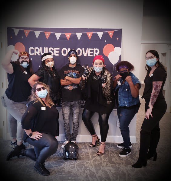 A group of people dressed in costumes and masks at a themed event.