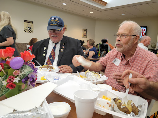 Veterans enjoying a meal together at a community event.