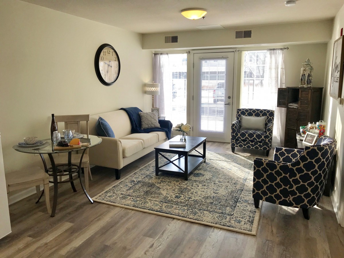 A cozy living room with stylish furniture and large windows allowing natural light.