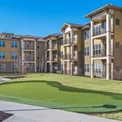 Modern apartment complex with well-maintained lawns and balconies.