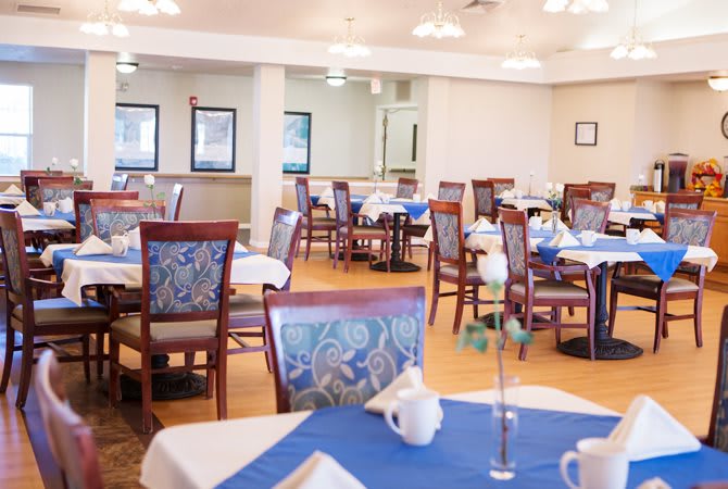 A restaurant dining area with neatly arranged tables and chairs.