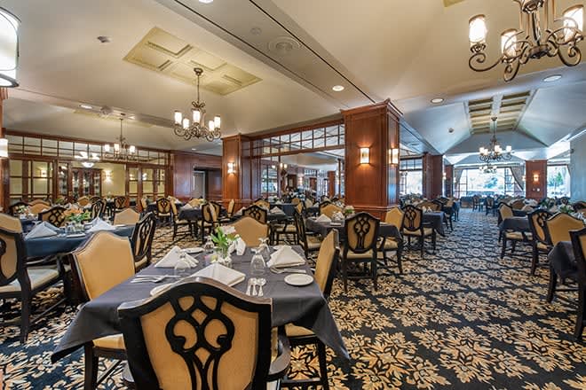 An elegant restaurant dining area with neatly set tables and classic decor.