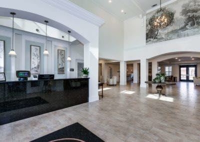 A spacious and modern lobby with a reception desk and elegant decor.
