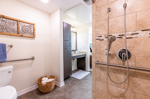 A modern bathroom featuring a stylish shower, vanity area, and neatly arranged towels.