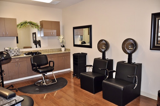 A modern hair salon interior featuring styling chairs and hairdryers.