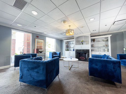 A modern lounge area featuring stylish blue sofas and a contemporary coffee table, perfect for relaxation.