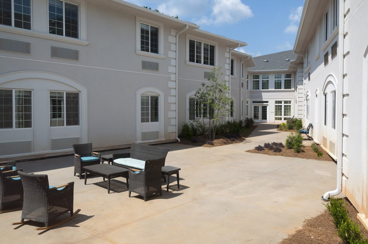 A peaceful courtyard with outdoor seating and modern architecture.