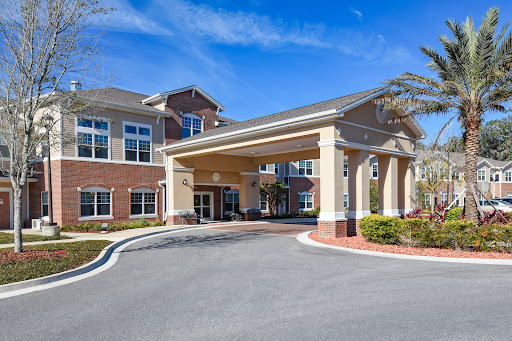 A welcoming entrance to a residential building, set against a clear blue sky.