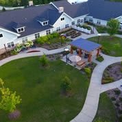 Aerial view of a residential building with landscaped gardens and pathways.