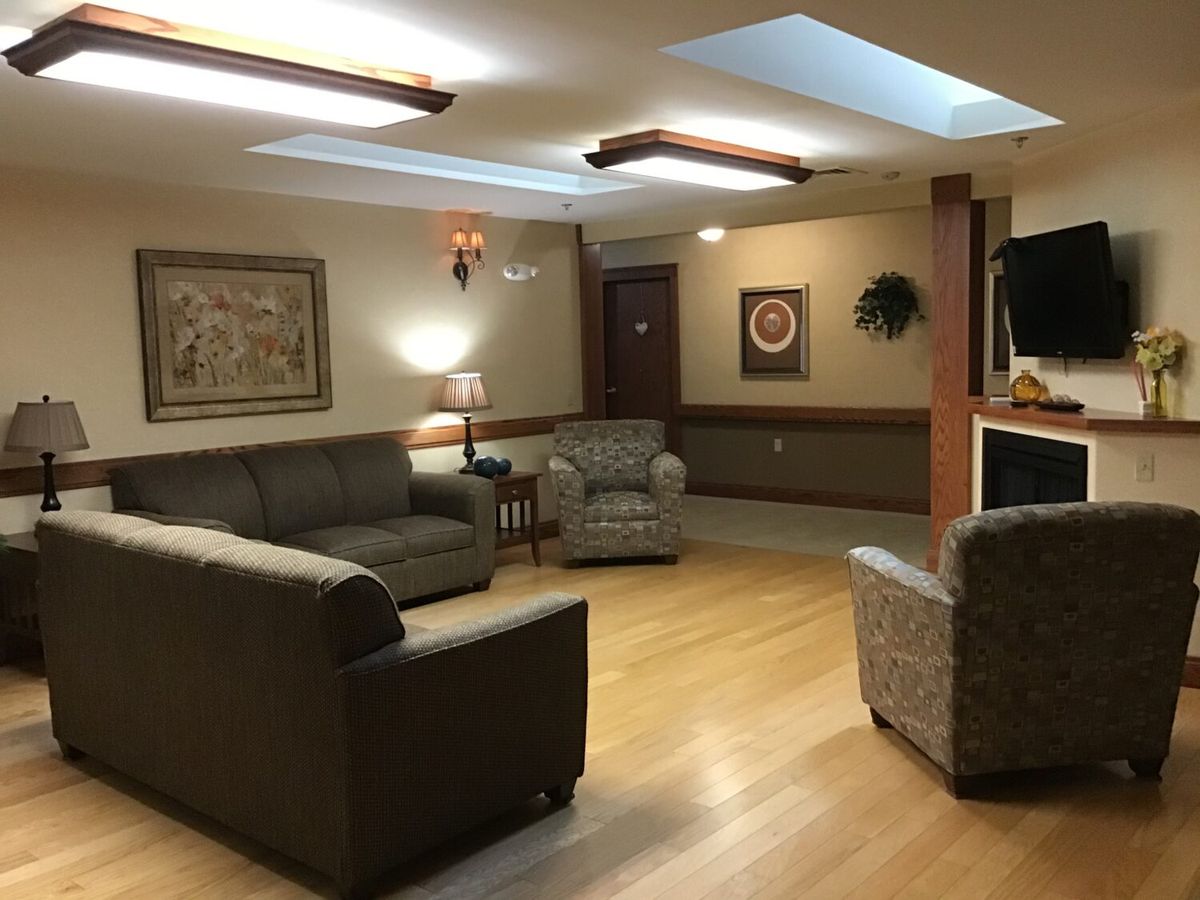A cozy living room with comfortable seating and warm lighting.