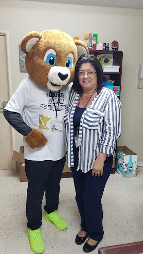 A joyful moment captured with a mascot at a local event.