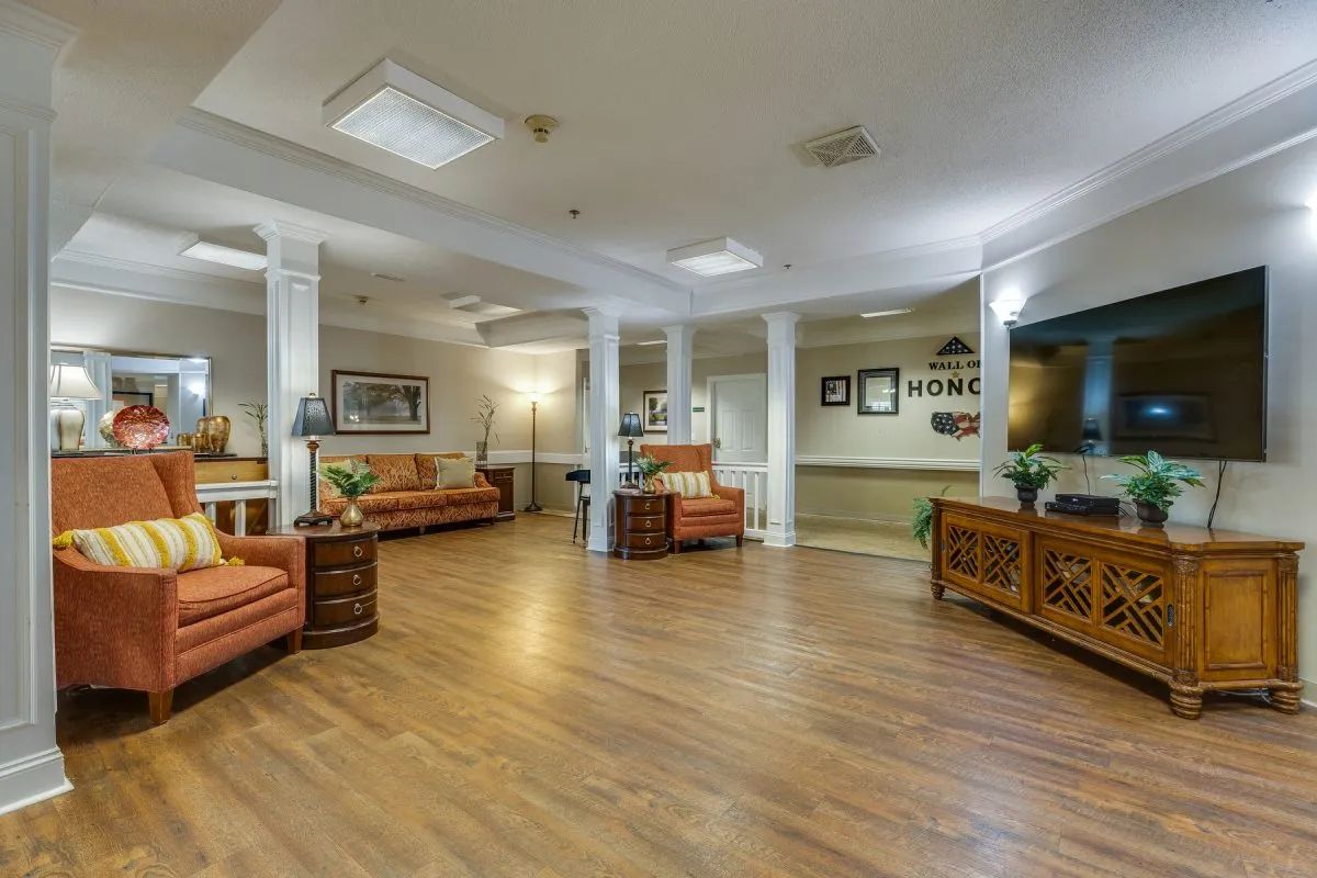 A spacious lobby area with comfortable seating and wood flooring.