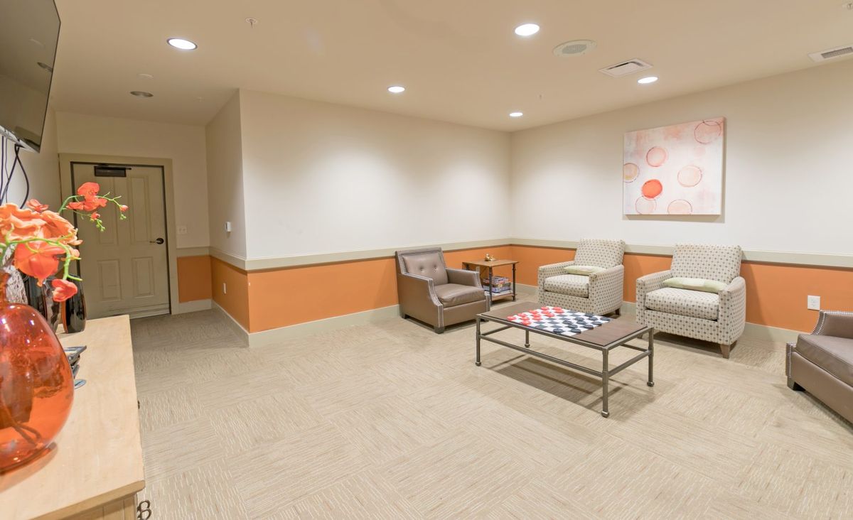 A modern waiting room with comfortable chairs and a coffee table.