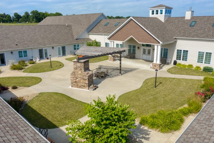 An aerial view of a residential complex with a central courtyard and landscaped surroundings.