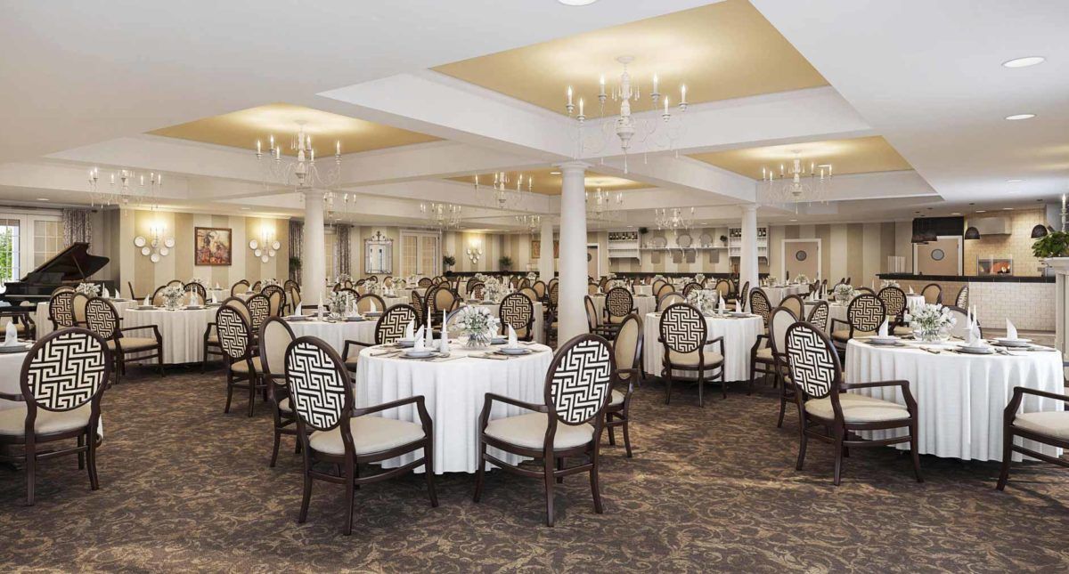 Elegant banquet hall with well-arranged round tables and chandeliers.