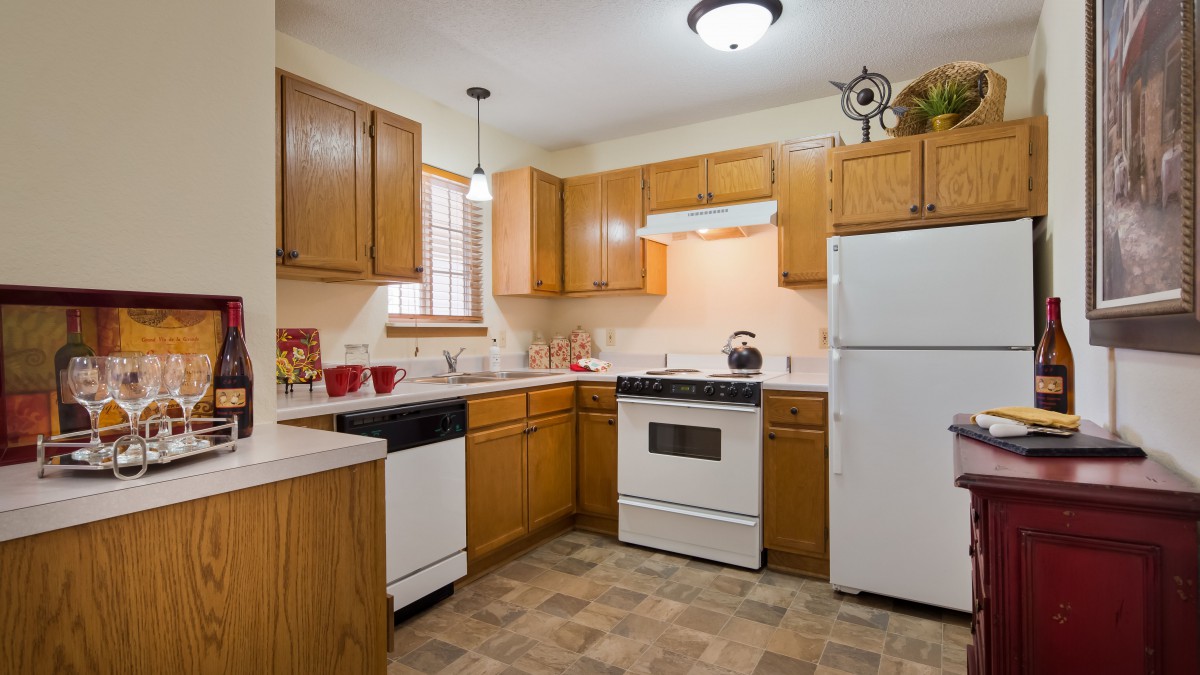 A cozy kitchen with wooden cabinets and modern appliances.