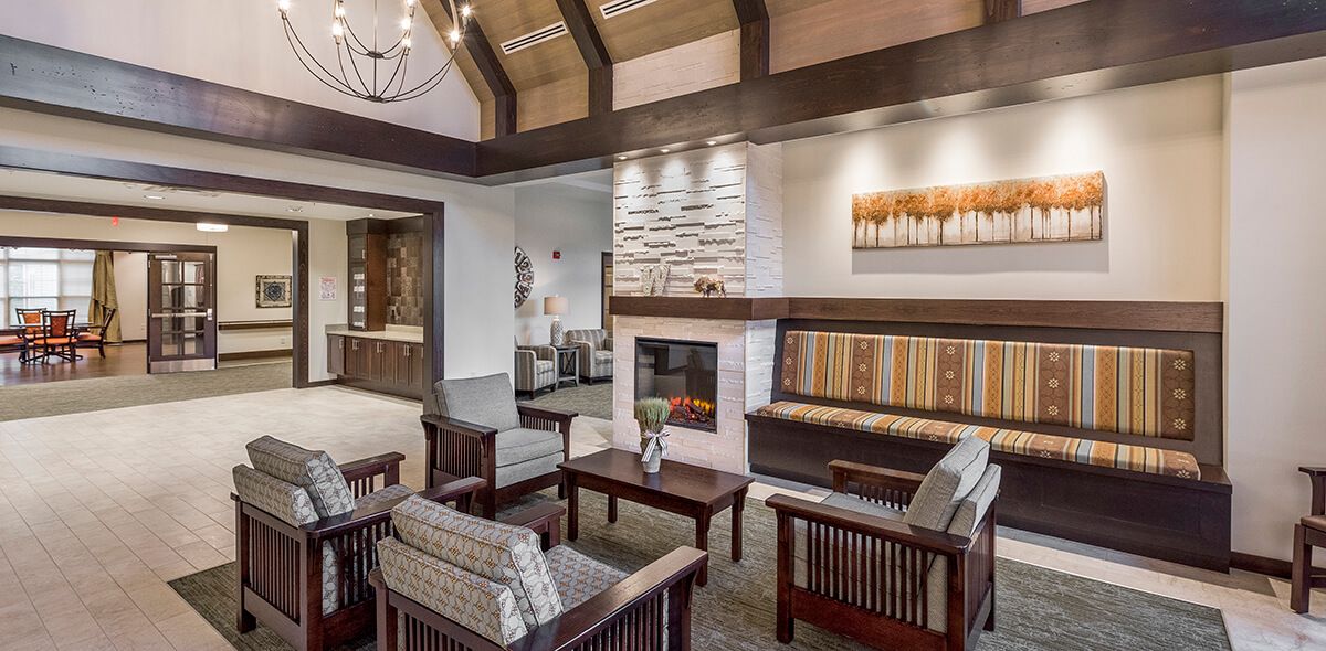 A cozy living room with modern wooden furniture and a fireplace.