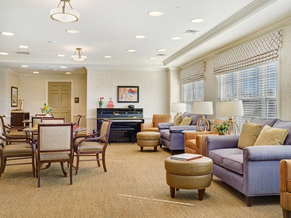 A cozy living room with comfortable seating and a piano.