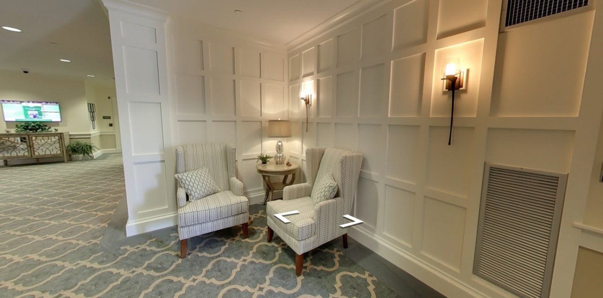 A cozy living room corner with upholstered chairs and a soft rug.