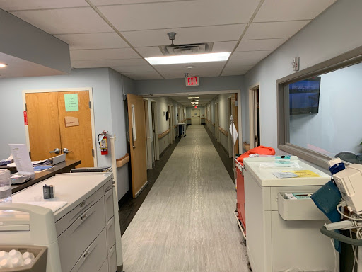 A view of a hospital hallway, showcasing the clean and organized layout typical of medical facilities.