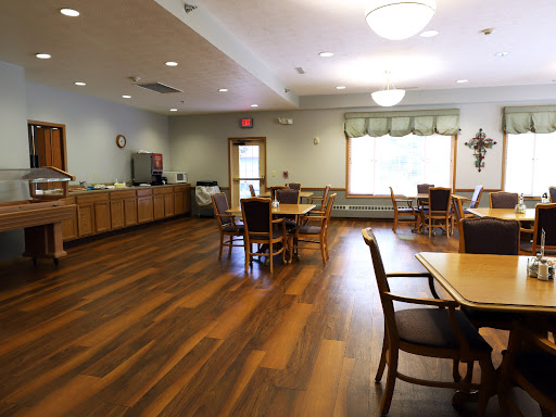 A spacious and inviting dining area featuring wooden floors and a warm atmosphere.