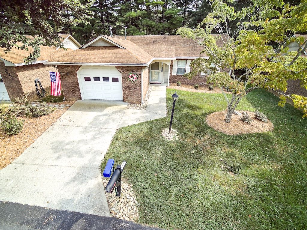 A suburban house with a driveway and well-maintained yard.