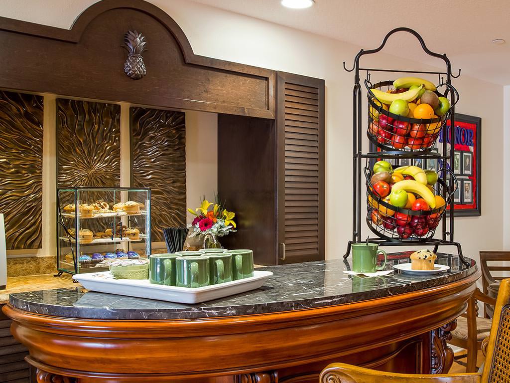 A well-organized hotel breakfast area featuring a variety of fresh fruits and pastries.