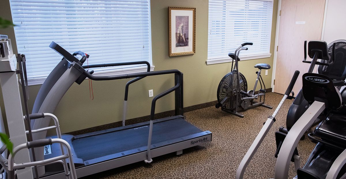 A small indoor gym with a treadmill and an exercise bike.