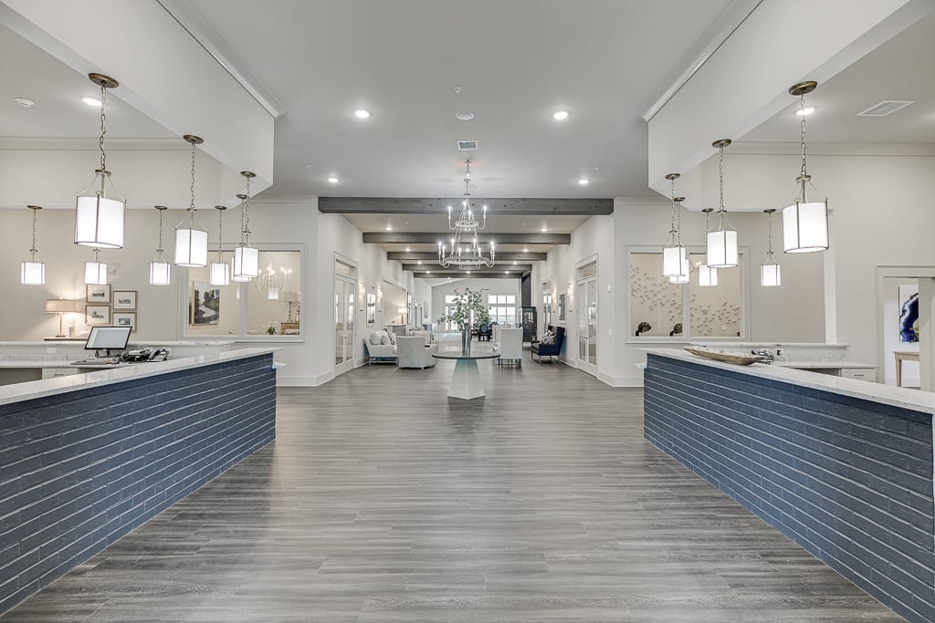A spacious, modern reception area with stylish lighting and wood flooring.