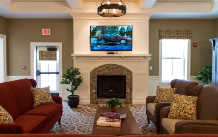 A cozy living room with a fireplace, television, and comfortable seating.