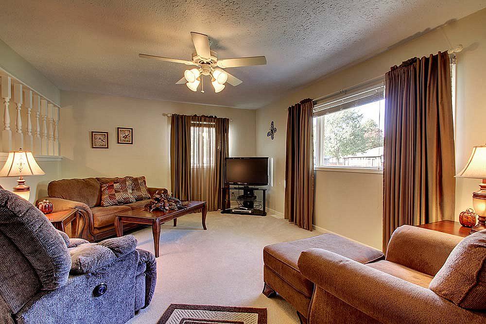Cozy living room with comfortable seating, a television, and warm decor.